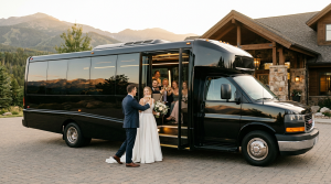 Bride and groom with Denver wedding party boarding limo bus at venue